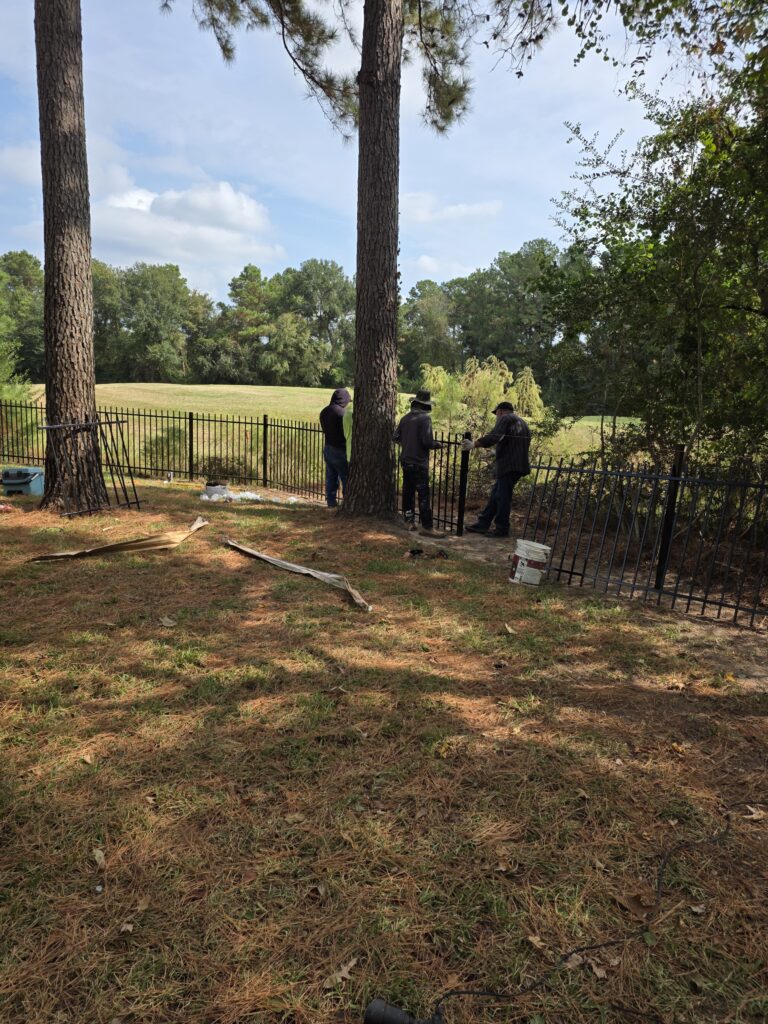 Fence installation team working in a backyard.