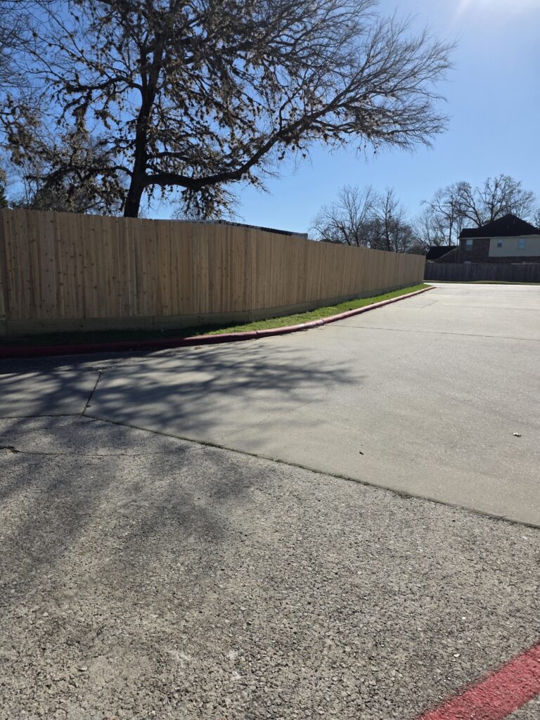 Commercial wood privacy fence installation.