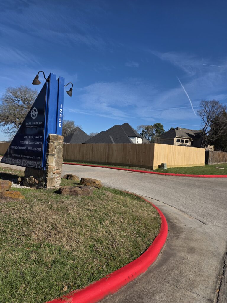 Wooden privacy fence behind a commercial sign.