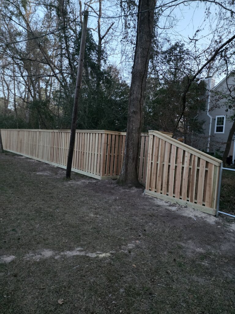 Shadowbox style wood fence with gate.