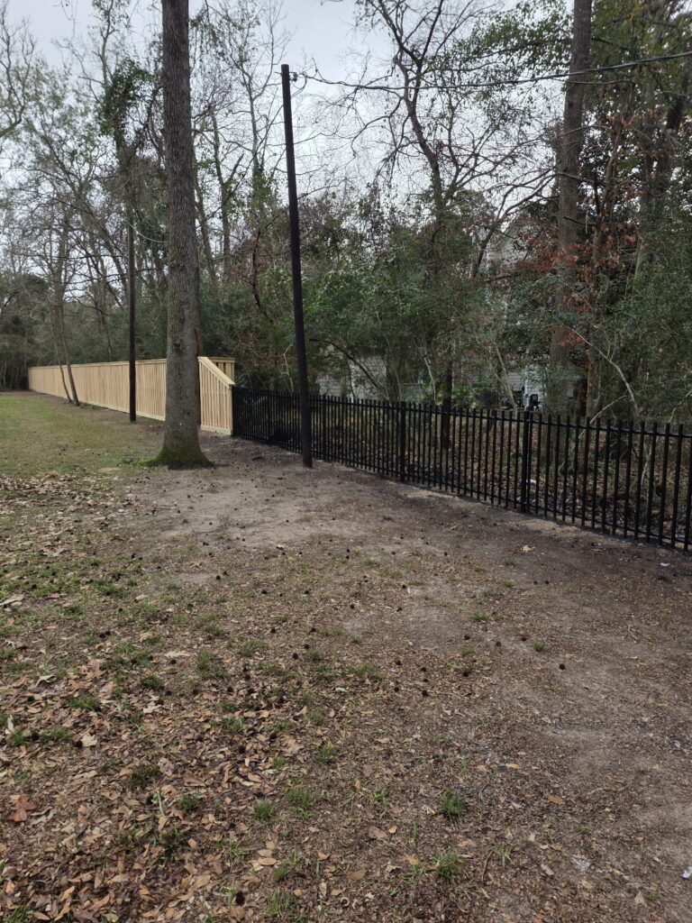 Combination of wood and black metal fencing.