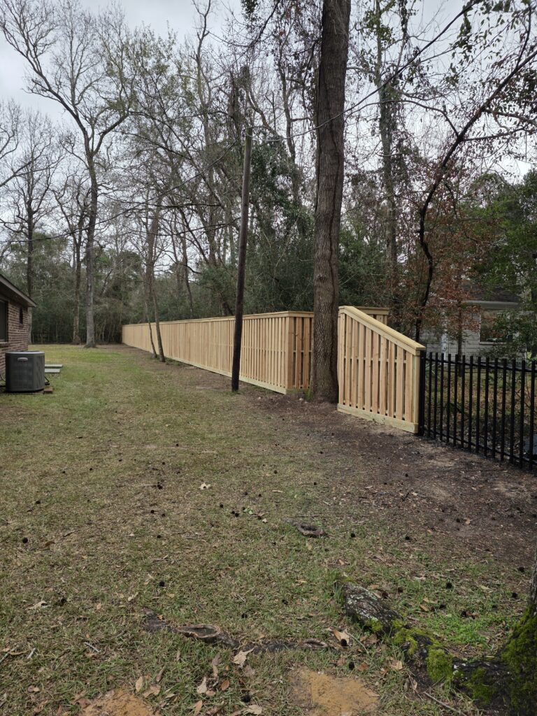 Long cedar shadowbox fence with black metal transition.